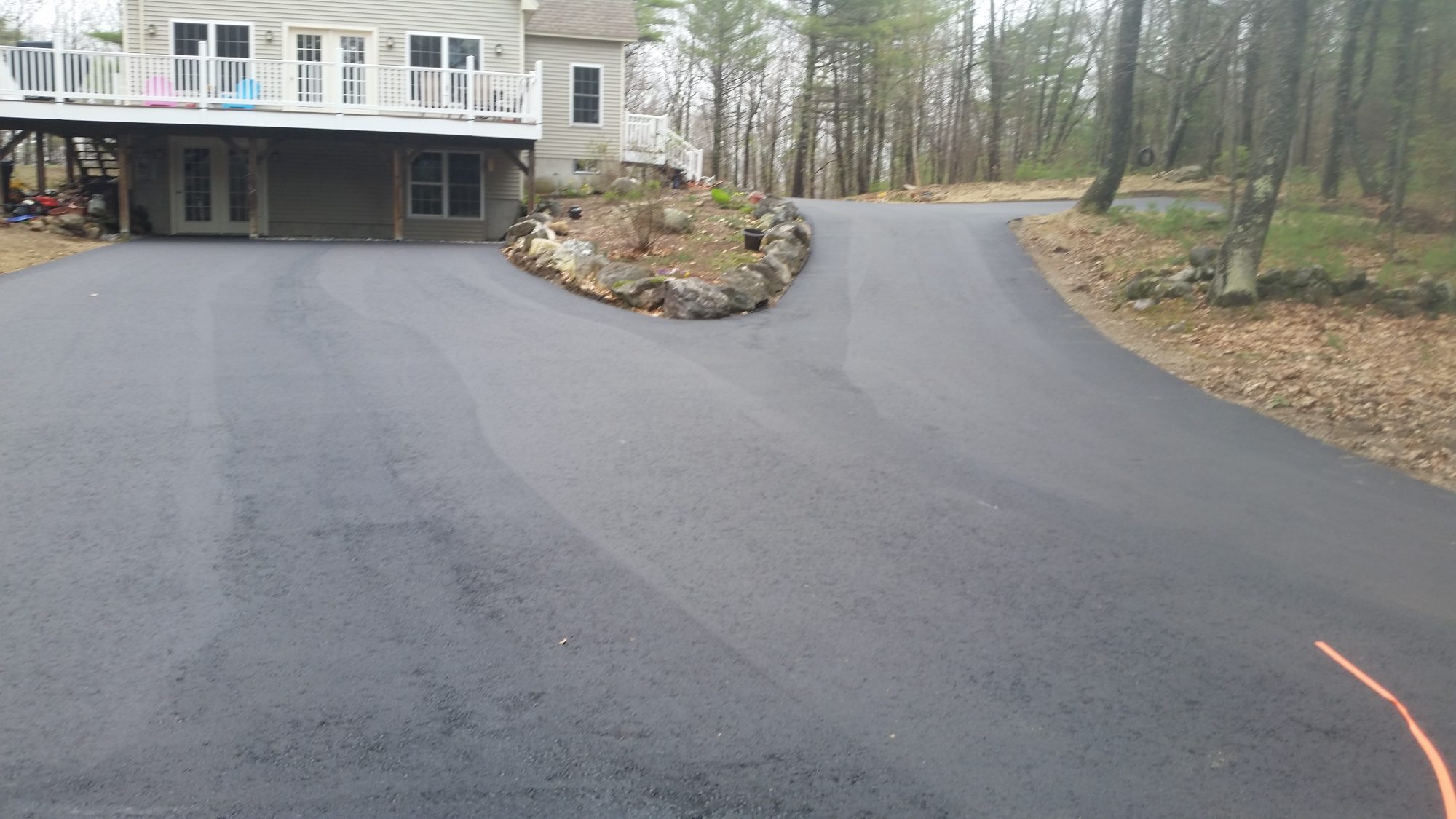 Freshly sealed asphalt driveway by D&R Paving